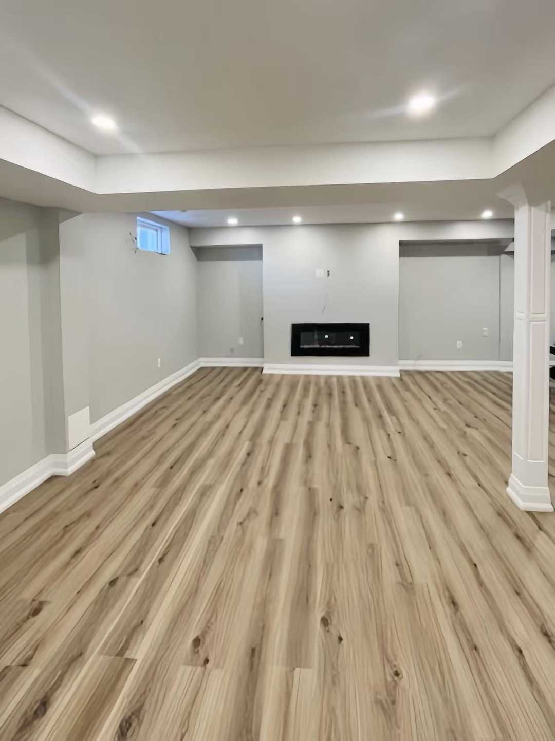 Grey vinyl flooring with built in tv wall, wet bar,