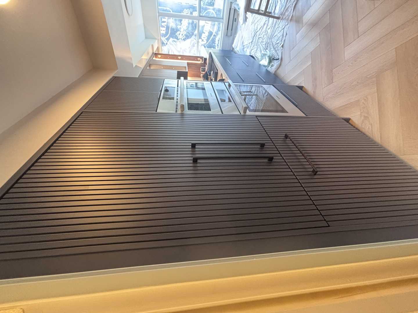 walnut wood panel with navy blue fluted kitchen, herringbone oak