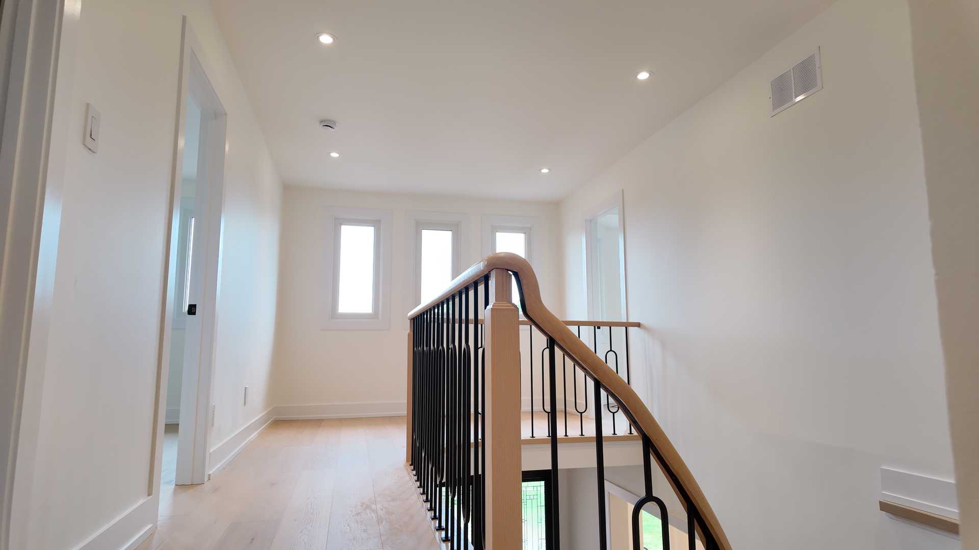 blonde wood flooring， with smooth rounded handrail